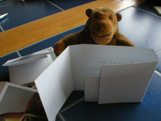 Mr Monkey folding flaps to make the card box