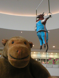 Mr Monkey beneath an acrobatic cow