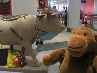 Mr Monkey with a cow which is also a sack of coffee beans