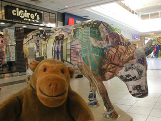 Mr Monkey with a cow covered in pictures of new Manchester buildings