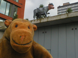 Mr Monkey below a cow in a pin-striped suit