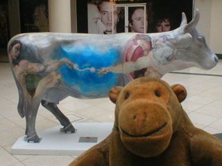 Mr Monkey with a cow decorated with Michelangelo's creation of Adam