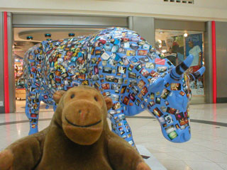 Mr Monkey with a blue cow covered in small photos