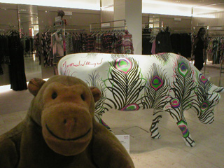 Mr Monkey with a cow decorated with peacock plumes