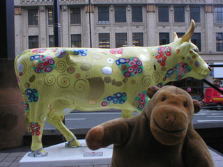 Mr Monkey in front of a cow inspired by Klimt