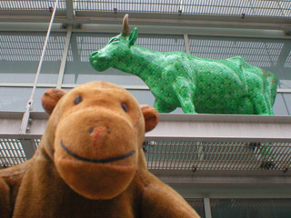 Mr Monkey beneath a green patterend cow