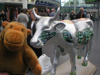 Mr Monkey with a silver cow with odd green patterned panels on its sides