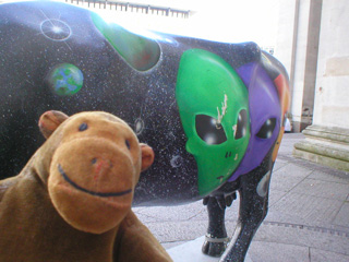 Mr Monkey with a cow decorated with alien heads
