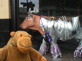 Mr Monkey with a silver suited cow behind him