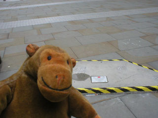 Mr Monkey looking at an empty plinth
