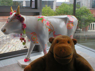 Mr Monkey wih a white cow, with abstract flourescent doodlings on it