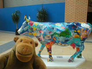 Mr Monkey with a brightly decorated cow