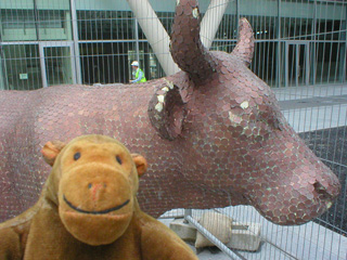 Mr Monkey closer to the penny covered cow