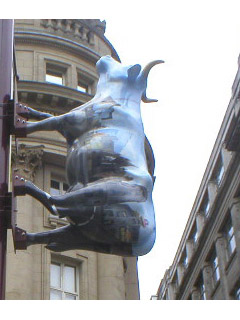 A cow with the Manchester skyline on its side