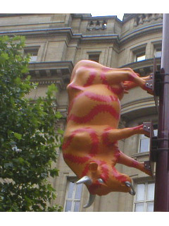 A cow decorated in orange and red