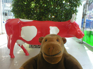 Mr Monkey with a red and white cow