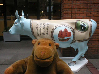 Mr Monkey with a cow decorated with a Chinese junk, a panda, and caligraphy