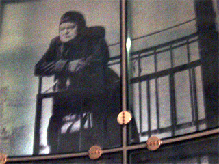 A black and white image of Ena Sharples on Urbis' glass wall