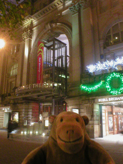 Mr Monkey looking at the front of the Royal Exchange Theatre