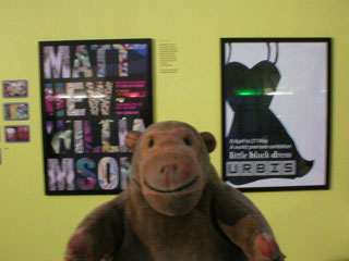 Mr Monkey looking at posters in the Design section