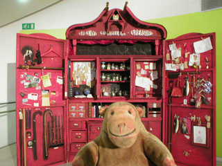 Mr Monkey looking at the Tiny Travelling Treasure cabinet in the Kids & families section