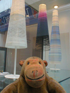 Mr Monkey looking at tall table lamps by Jenny Bland