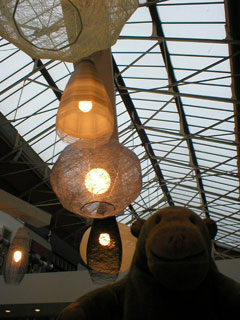 Mr Monkey looking at lampshades by Jenny Bland