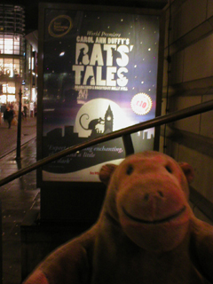 Mr Monkey looking at the Rats' Tales poster outside the theatre