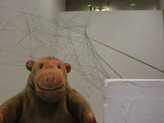 Mr Monkey looking at the installation by Meiling Tse from the top of the stairs