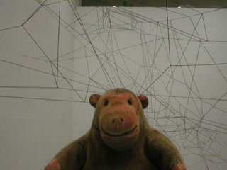 Mr Monkey looking at Meiling Tse's installation from part way down the stairs