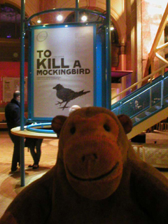 Mr Monkey looking at the To Kill A Mockingbird poster inside the theatre