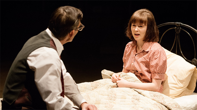 Atticus Finch (Nigel Cooke) comforts Scout Finch (Shannon Tarbet) (Royal Exchange Theatre production photo)