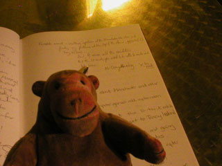 Mr Monkey signing the Urbis memory book