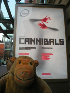 Mr Monkey looking at the Cannibals poster outside the theatre