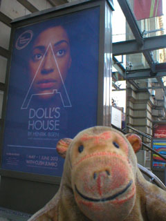 Mr Monkey looking at the A Doll's House poster outside the theatre