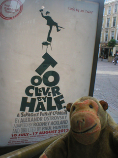 Mr Monkey looking at the Too Clever By Half poster outside the theatre