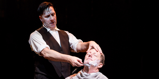 Sweeney Todd (David Birrell) studies Judge Tirpin's (Don Gallagher) throat (Royal Exchange Theatre production photo)