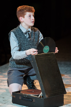 Young Jimmy (William Haresceugh) plays his forbidden gramophone (Royal Exchange Theatre production photo)