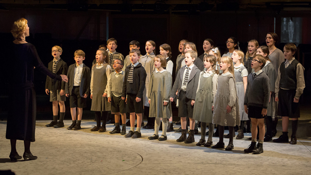 Miss Riall (Kelly Price) leads the children's choir (Royal Exchange Theatre production photo)
