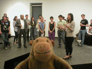 Mr Monkey listening to the exhibition introduction