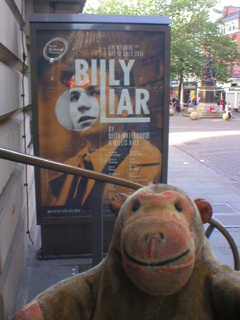 Mr Monkey looking at the Billy Liar poster