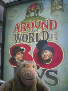 Mr Monkey looking at the Around the World in Eighty Days poster