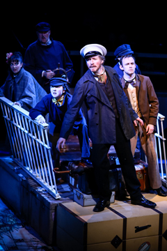 Almost the entire cast trying to reach Liverpool (Royal Exchange Theatre production photo)