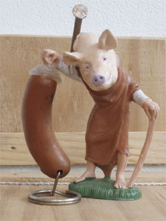 A pig headed man holding up a sausage on one of Maddi Nicholson's Penthouse Apartments