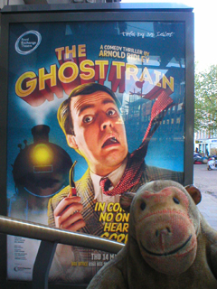Mr Monkey looking at the The Ghost Train poster