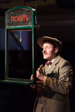 Teddy (Calum Finlay)  peers through the ticket office window (Royal Exchange Production photo)