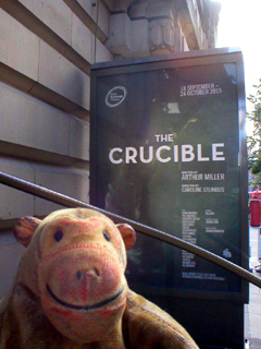Mr Monkey looking at the The Crucible poster
