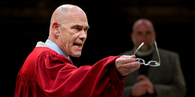 Peter Guinness as Deputy Governor Thomas Danforth, with Stephen Kennedy as Reverend Samuel Parris in the background (Royal Exchange Production photo by Jonathon Keenan)