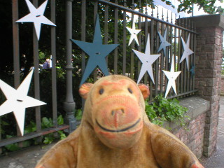 Mr Monkey looking at stars attached to railings