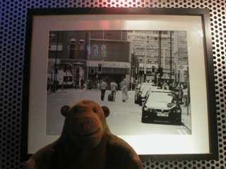 Mr Monkey looking at a black and white street scene